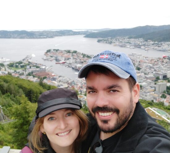 Selfie of Estera and Narot with the landscape of Bergen, Norway, behind.